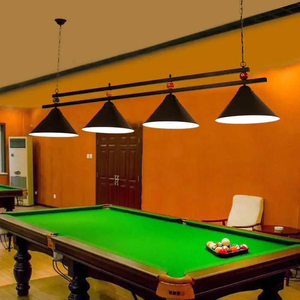 Black metal hanging island light with conical shades suspended above pool table for industrial billiard club use