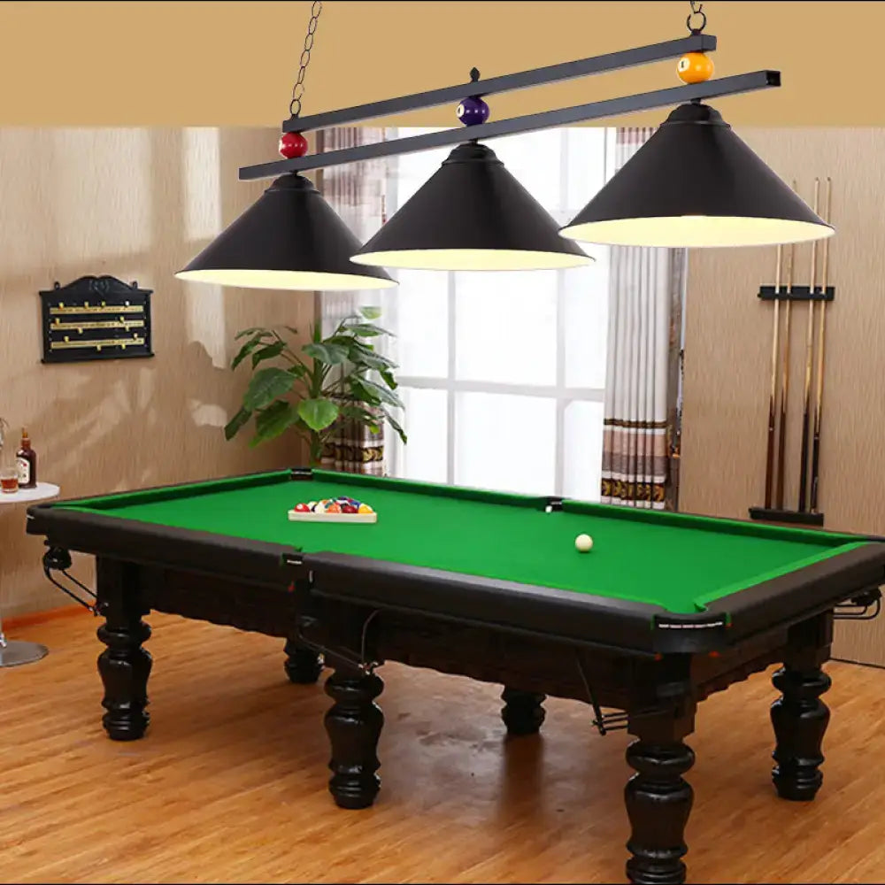 Decorbites metal hanging island light features a black wrought iron hanging island light over a green felt pool table
