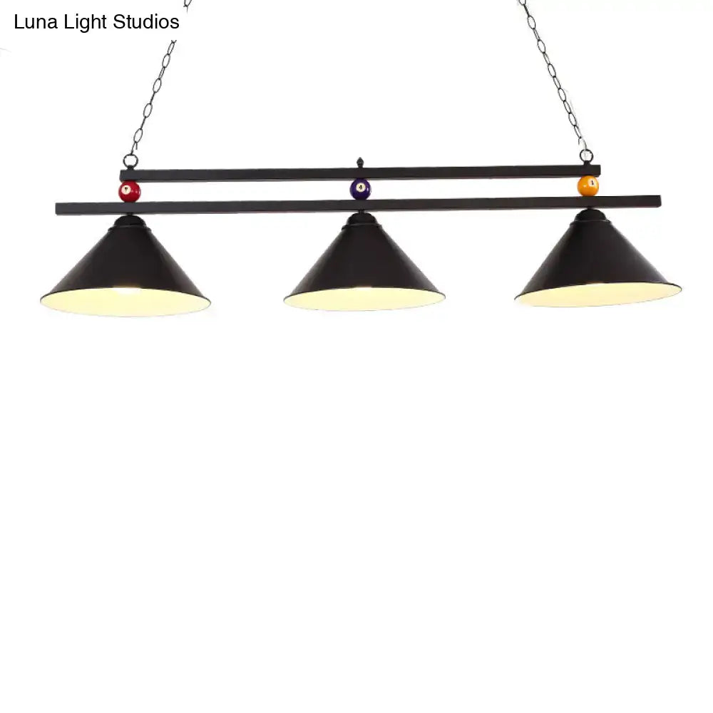 Black metal hanging island light with three conical shades and decorative billiard ball accents for industrial use