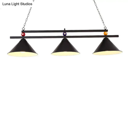Black metal hanging island light with three conical shades and decorative billiard ball accents for industrial use