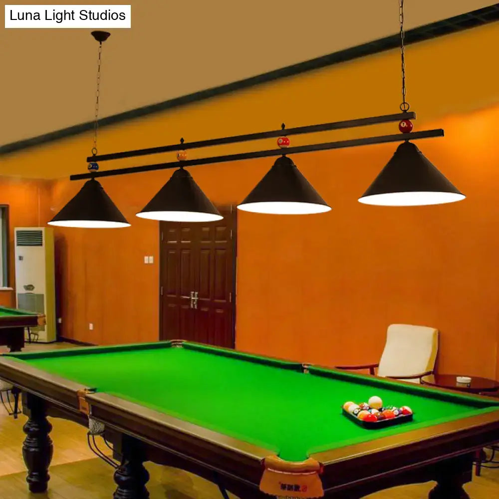 Black conical metal hanging island lights with a sleek metal frame hang above the pool table in an industrial style