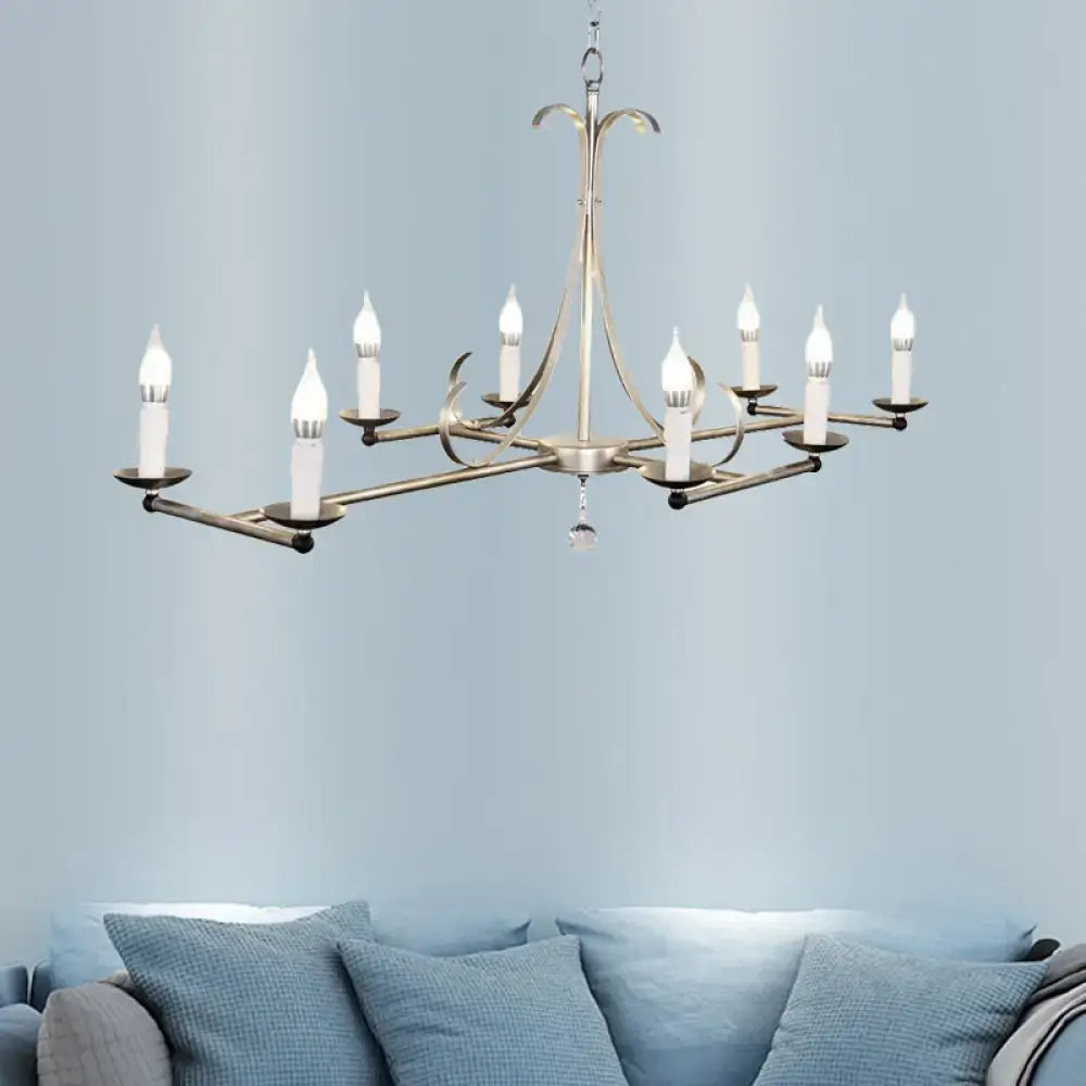 Antique brass metal island chandelier with nine traditional candle bulbs and a crystal accent by DecorBites
