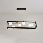 Black rectangular metal pendant light with gold accents and milk glass shade for industrial dining rooms