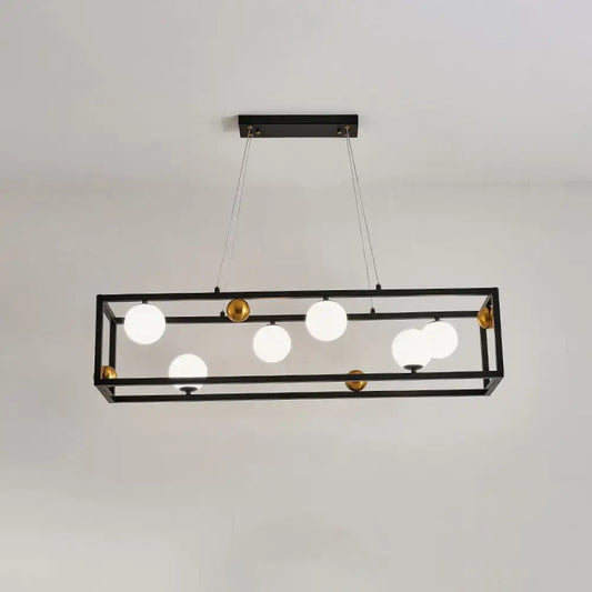 Black rectangular metal pendant light with gold accents and milk glass shade for industrial dining rooms
