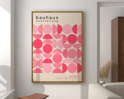 A framed decorbites™ mid century geometric canvas wall art with pink overlapping circles and bauhaus exhibition text