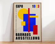 A decorbites™ mid century geometric canvas wall art with yellow blue and red shapes and black text on cream background