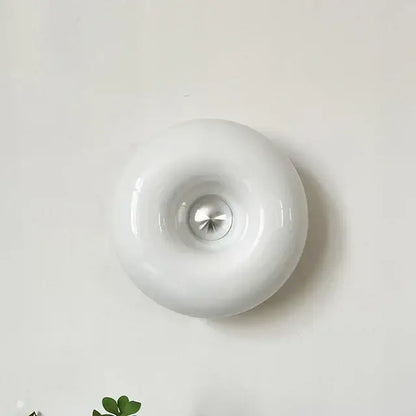 White glossy ceramic wall-mounted light fixture with central metallic accent for modern desk lamp decorbites bauhaus design