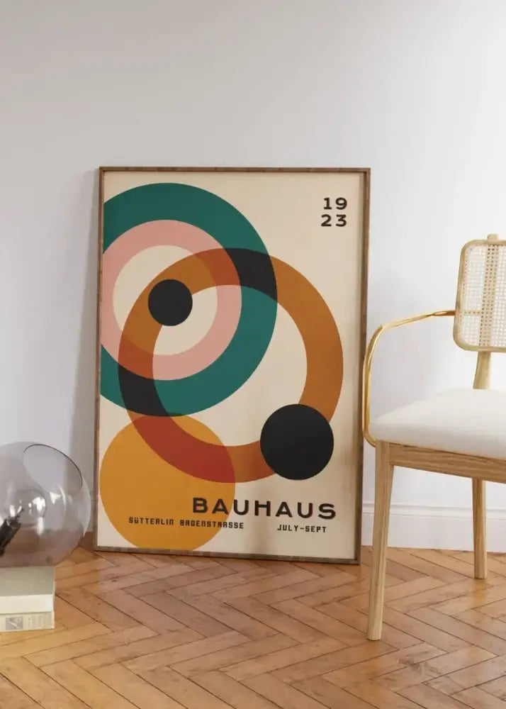 A framed decorbites™ mid century modern poster featuring teal pink orange and black concentric circles on a cream background