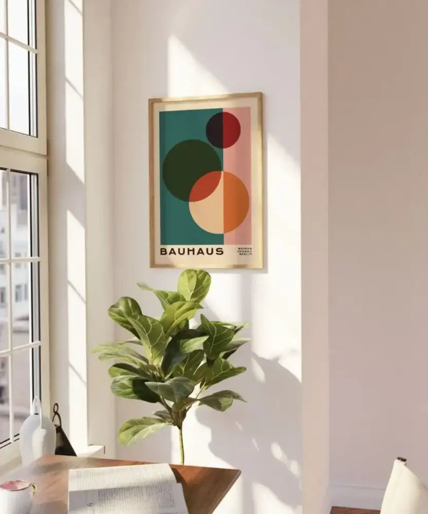 A framed decorbites™ mid century modern geometric wall art with bold teal red orange and green circles on pink