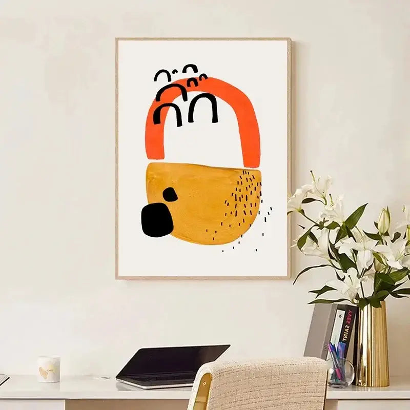 Abstract art print in a light wood frame featuring bold orange and mustard yellow watercolor brush strokes by decorbites