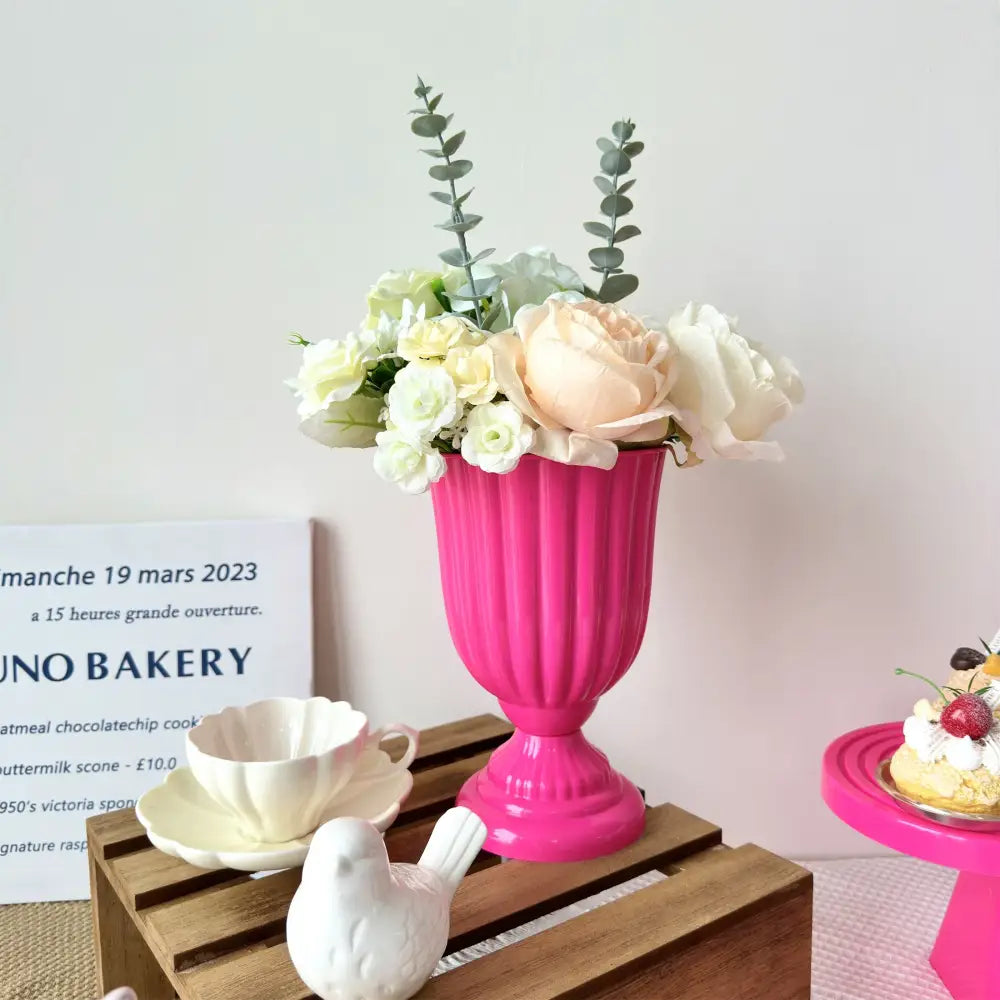 Vibrant pink ribbed ceramic decorbites™ mini flower arrangement vase with cream and pale peach roses and eucalyptus sprigs