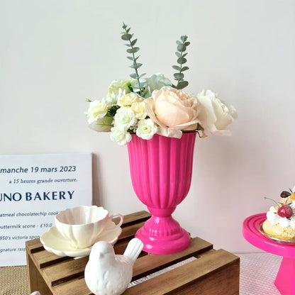 Vibrant pink ribbed ceramic decorbites™ mini flower arrangement vase with cream and pale peach roses and eucalyptus sprigs