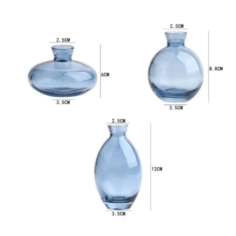 Set of three translucent blue glass DecorBites™ mini flower vases with rounded bulbous shapes and narrow necks for decor