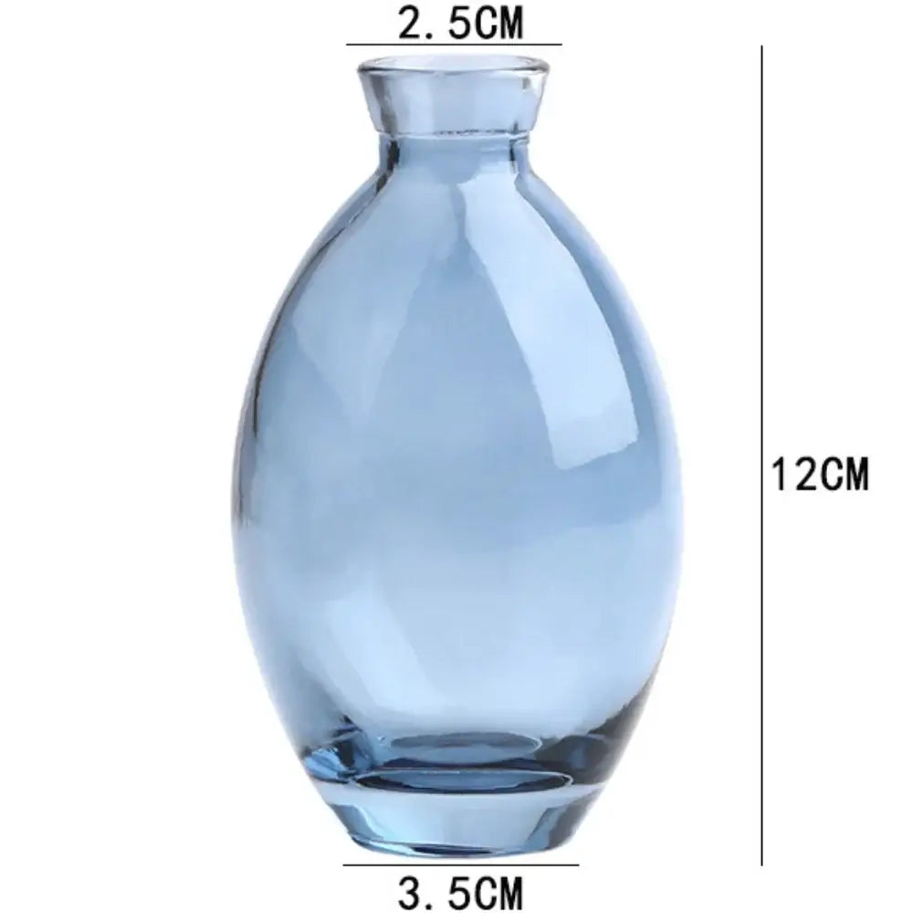 DecorBites™ mini glass flower vase made of translucent light blue glass with rounded body and narrow neck for home decor