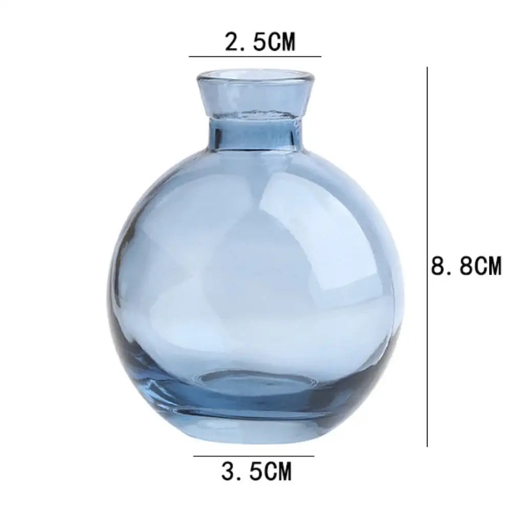 Decorbites™ mini glass flower vase made of translucent light blue glass with a rounded body and short neck for home decor