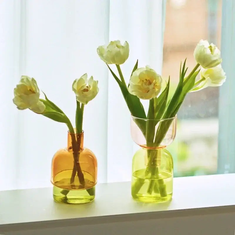 DecorBites™ mini glass vase set features amber and lime green translucent glass vases holding white tulips