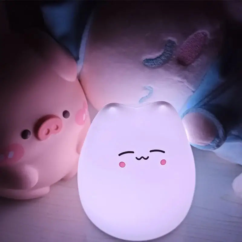 A soft glowing white decorbites mini popular cat night lamp with power switch and color-changing eye protection for children