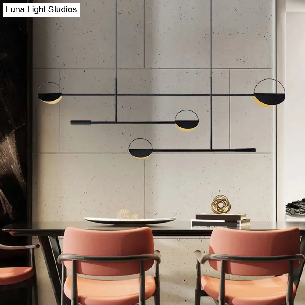 Decorbites minimalist black metal pendant light with circular half-moon shades emitting warm glow for dining room