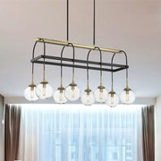 Modern black and brass island pendant light featuring seven clear glass globe bulbs by DecorBites™
