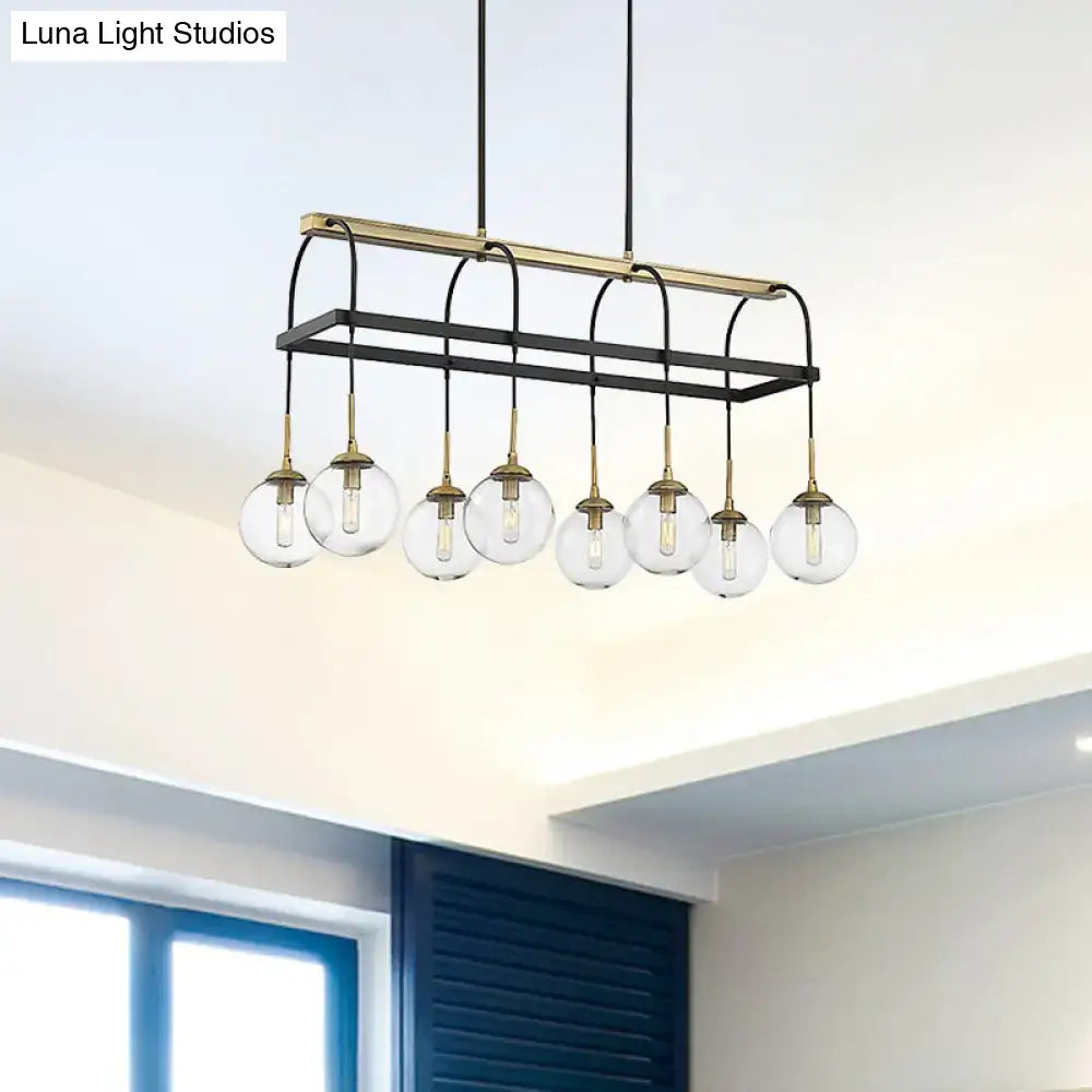Modern black and brass rectangular island pendant with six clear glass globe bulbs for minimalist décor