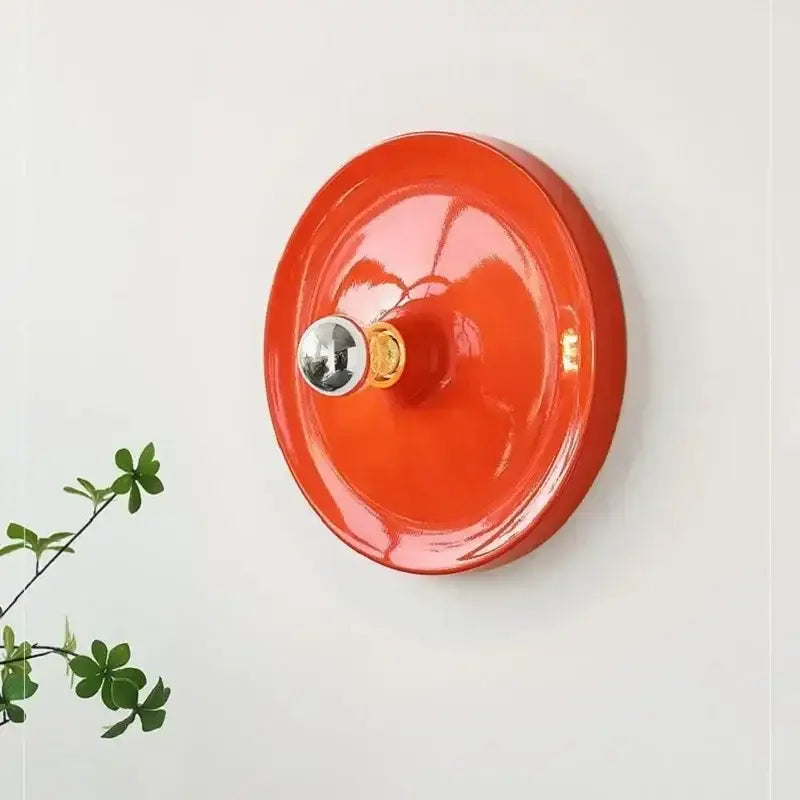 Vibrant orange ceramic bauhaus lamp with glossy finish and metallic silver knob from decorbites bauhaus collection