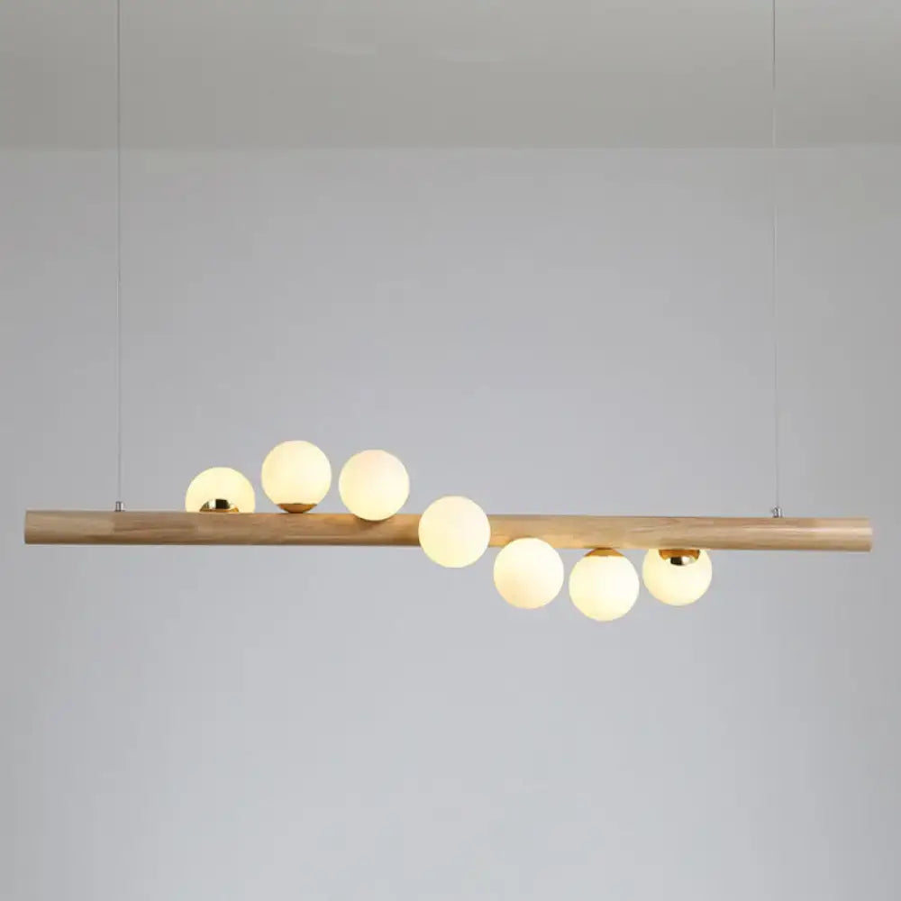 Modern pendant light with natural wood bar and six frosted glass globes by decorbites ball island pendant light