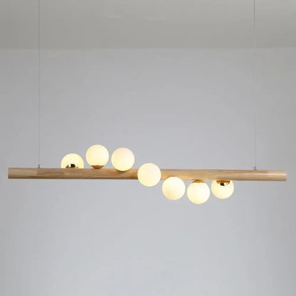 Modern pendant light with natural wood bar and six frosted glass globes by decorbites ball island pendant light