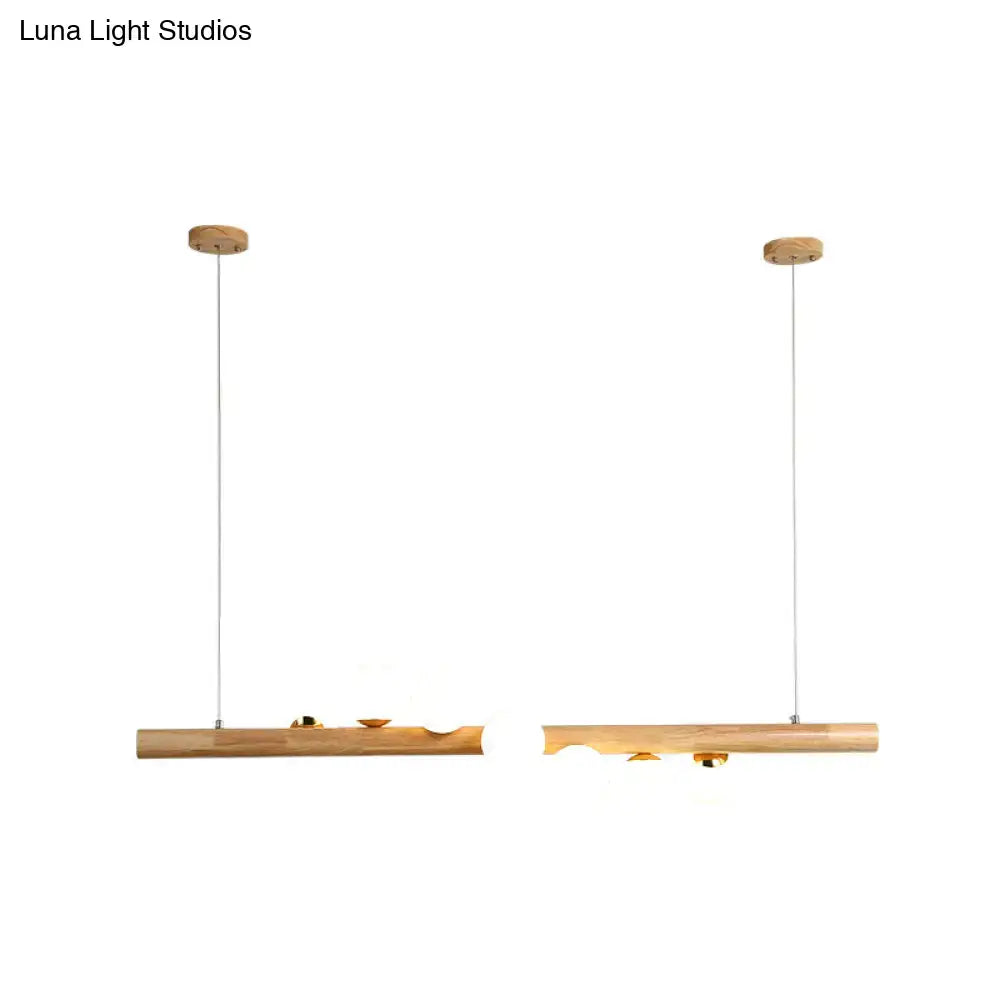 Two minimalist wooden pendant lights with natural wood finish and brass accents from decorbites ball island pendant series
