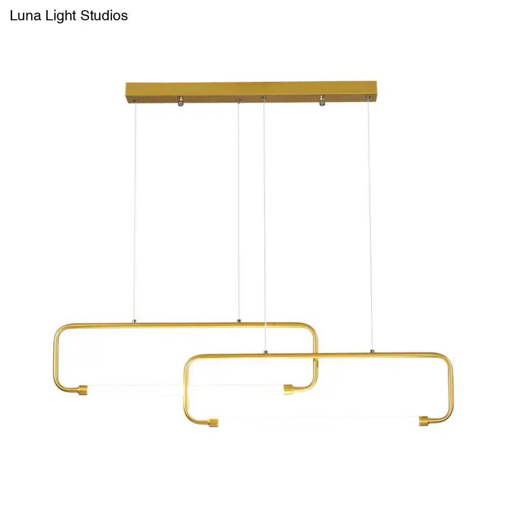 Gold-finished DecorBites™ minimalist geometric LED dining room pendant light with overlapping rectangular frames and black gold color remote