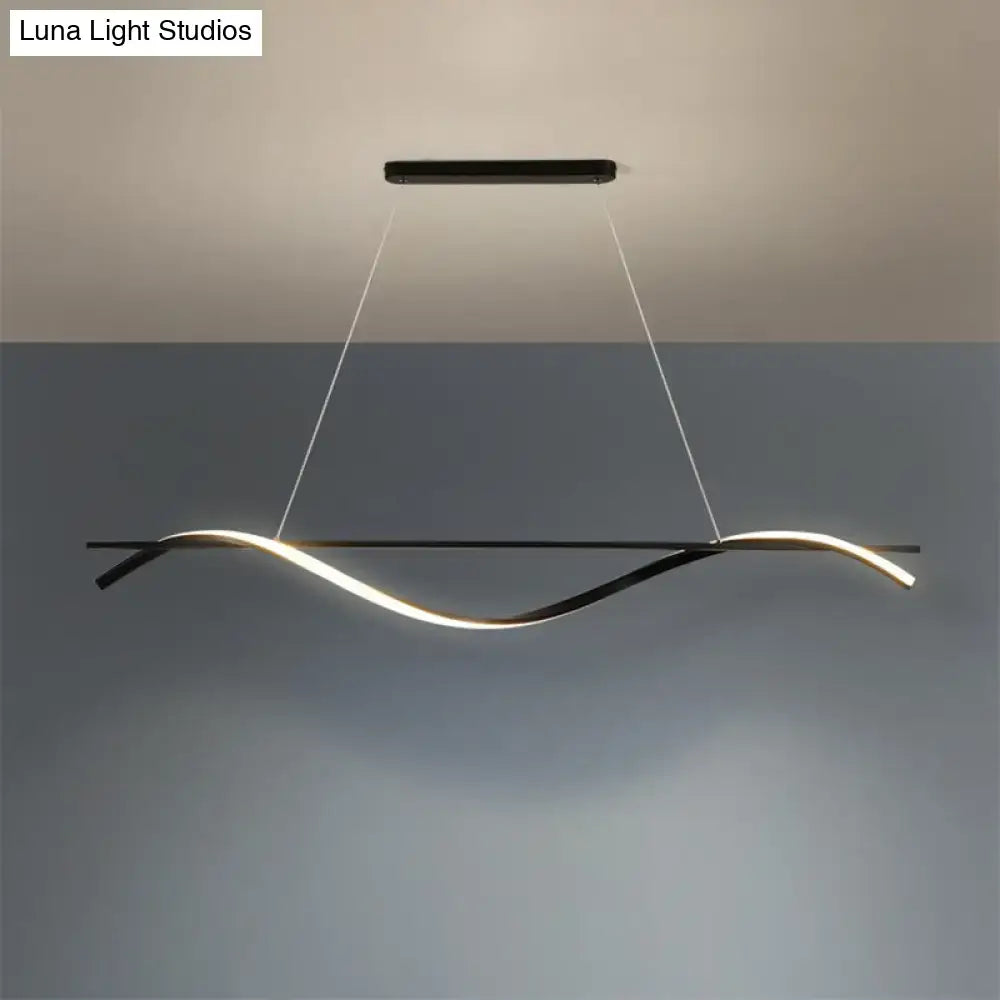 Modern black DecorBites™ minimalist LED hanging island light with curved strip emitting warm white illumination