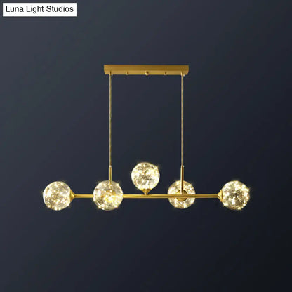 DecorBites™ minimalist ceiling light with gold-toned brass finish and clear glass sphere shade featuring five crystal bulbs