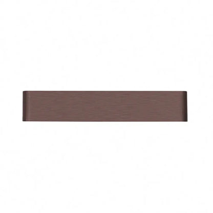 A sleek rectangular drawer pull with matte bronze finish complements a minimalist black and silver wall lamp for living room warm white light