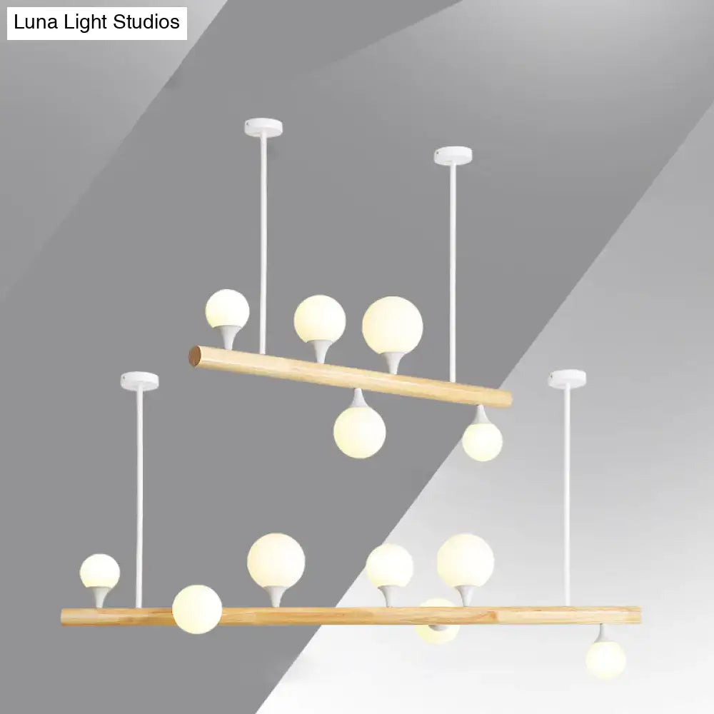 Modern two-tier decorbites™ linear hanging island pendant light with natural wood bars and white opal glass globes for restaurants