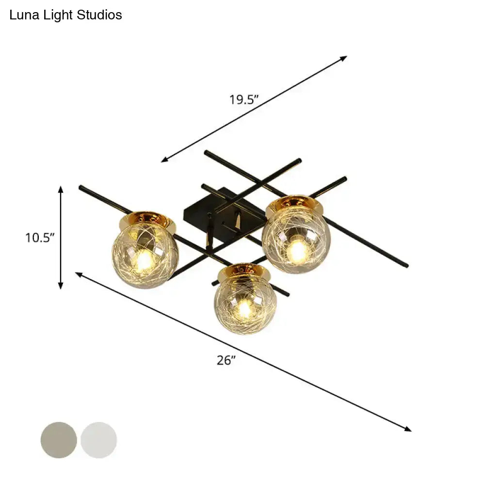 Modern black metal 3-head semi-flush ceiling light with clear smoke gray textured glass globes and gold-toned rims for bedroom