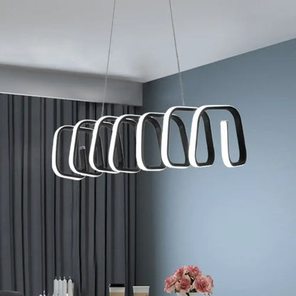 Modern black and white metal LED island light with a sleek geometric design for dining room ceilings by DecorBites