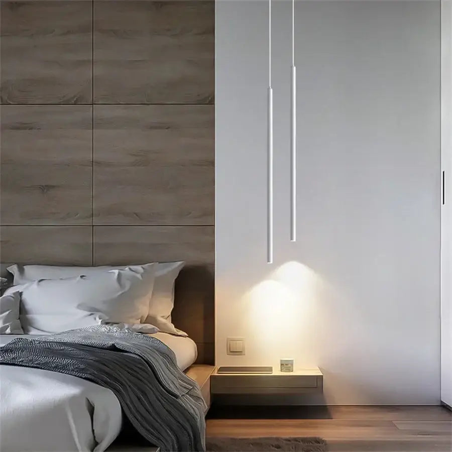 Minimalist white cylindrical decorbites™ modern 2cm led pendant lights cast warm glow on bedside table