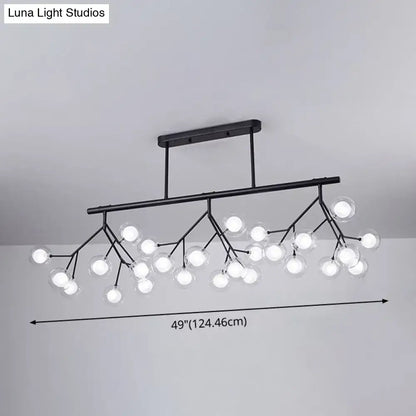 Black metal DecorBites™ firefly island pendant with 27 clear glass globe bulbs in a branching island pendant design