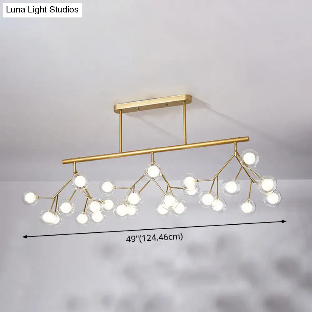 Gold-toned modern firefly island pendant with clear glass globes in acrylic design for dining room lighting