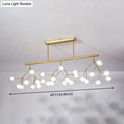 Gold-toned modern firefly island pendant with clear glass globes in acrylic design for dining room lighting