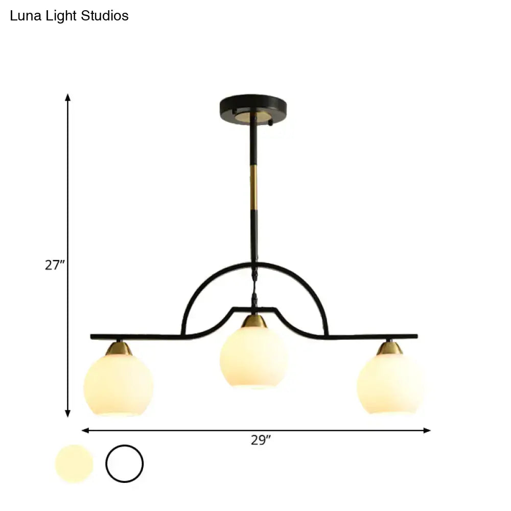 DecorBites modern arched island pendant light with black brass finish and three clear white glass globe shades