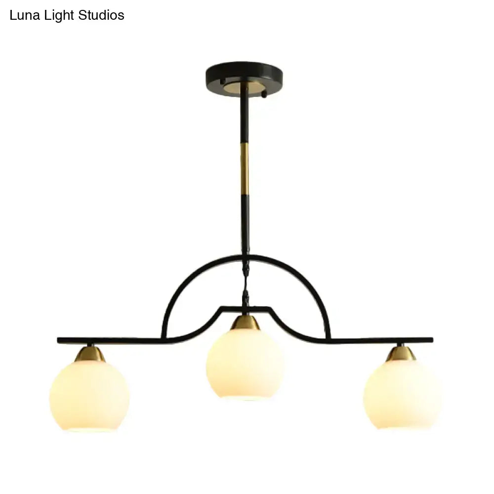 Decorbites modern arched island pendant light with black and brass finish and three clear white glass globe shades