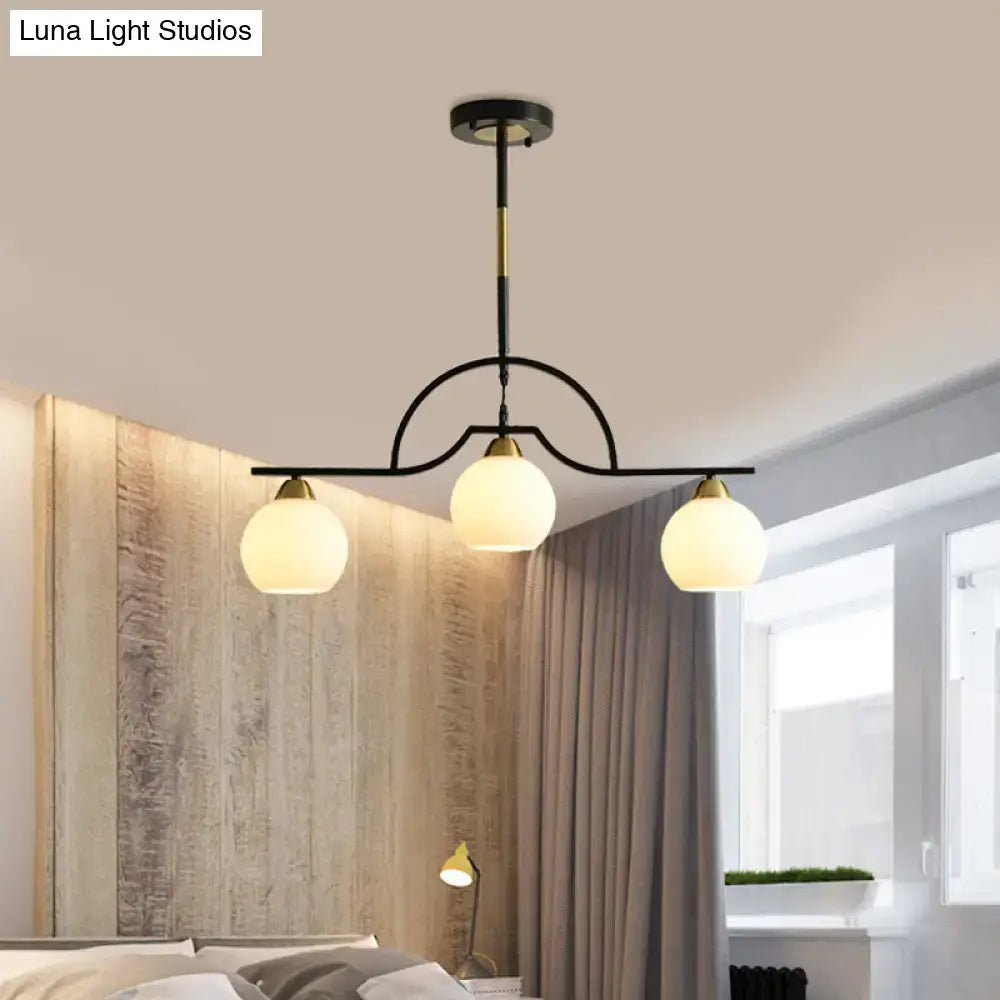 DecorBites modern arched pendant light with black brass finish and three clear white glass globe shades