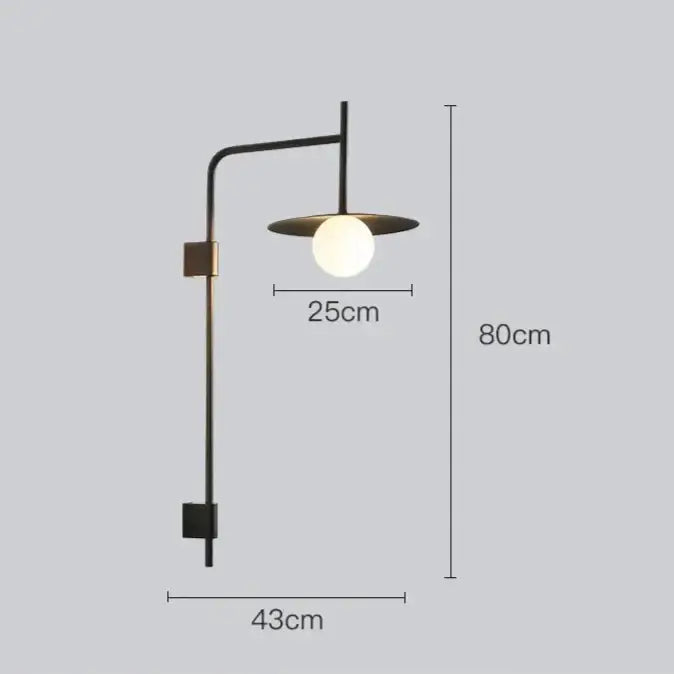 Modern black metal wall light with frosted glass globe and circular shade for bedside wall use by decorbites