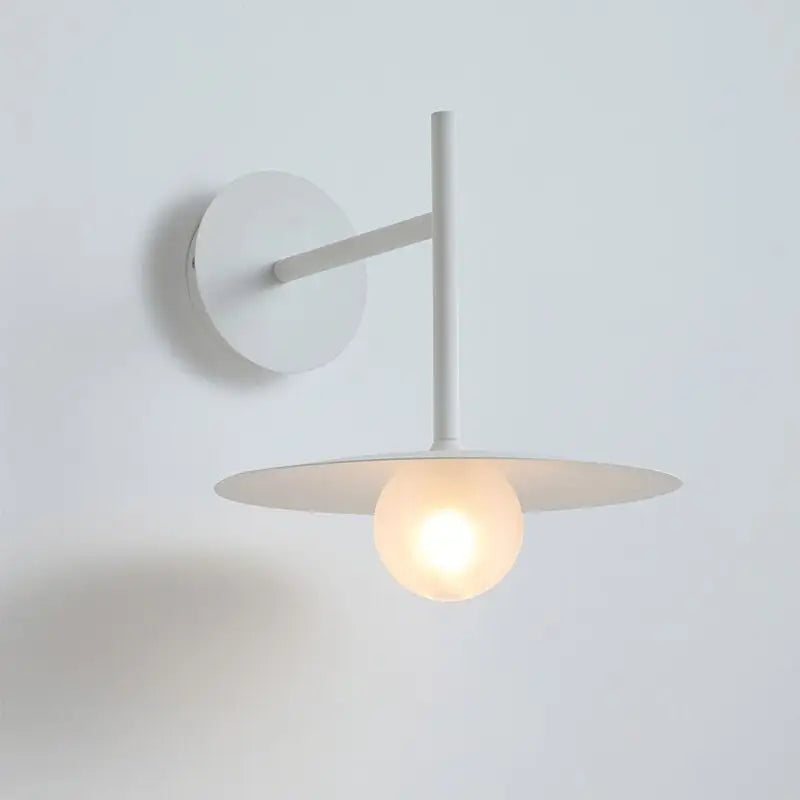 Decorbites™ modern bedside wall light with a minimalist white circular base and flat disc shade cradling a globe bulb