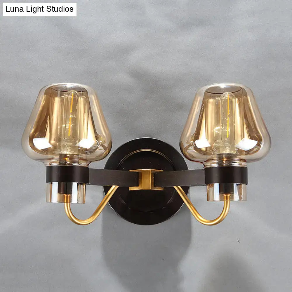 Modern black and gold amber glass mushroom sconce light fixture with double-light amber glass shades and black metal base