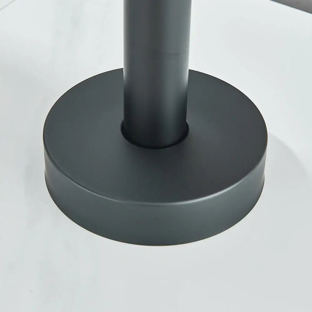 Matte black cylindrical table leg with circular base featured in DecorBites™ modern black floor mounted tub faucet design