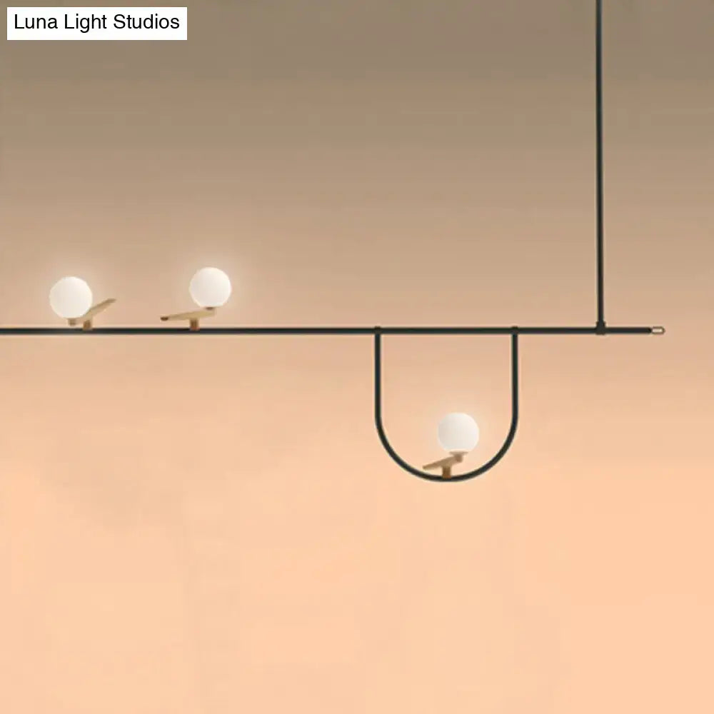 DecorBites modern black glass sphere island light fixture with three white glass bulbs on wooden perches ceiling mounted