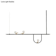 Minimalist black metal light fixture with three white glass sphere shades and cream accents for glass sphere island lighting