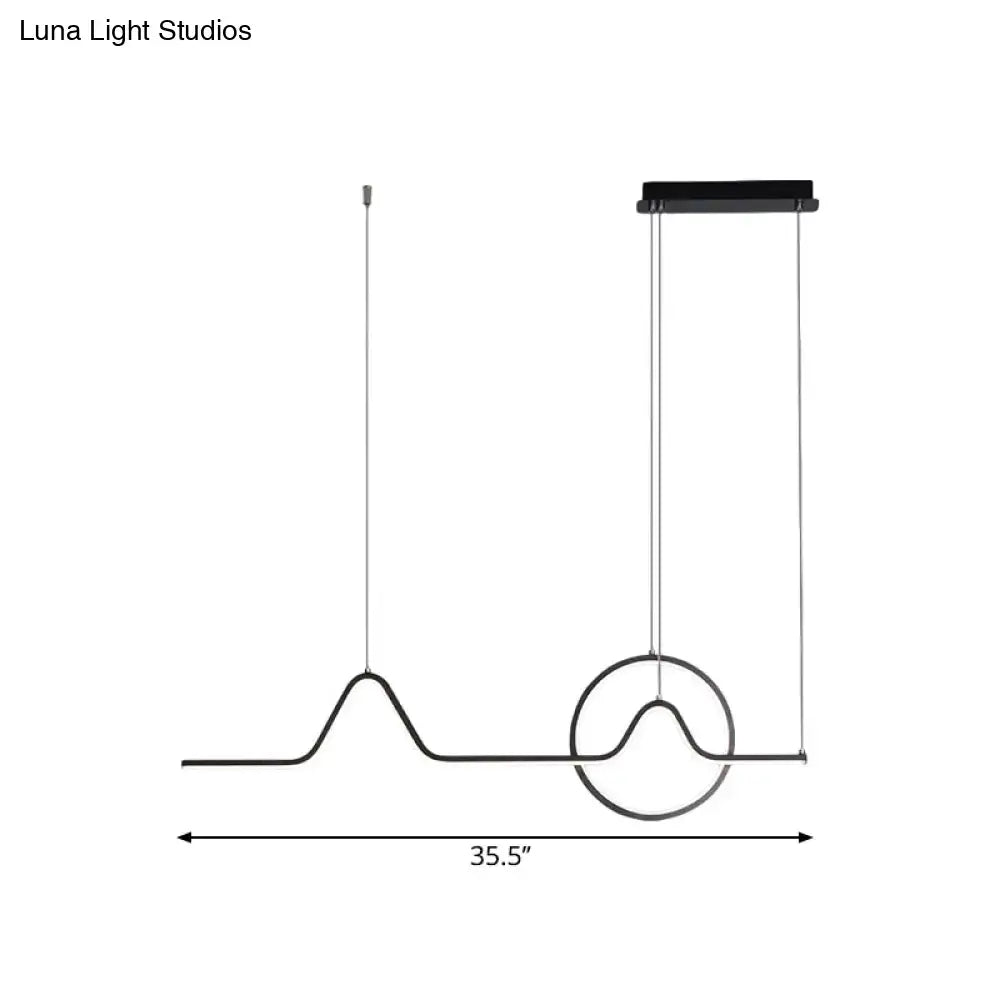 Modern black metal pendant ceiling light with sleek wave design and circular accent featuring warm white light