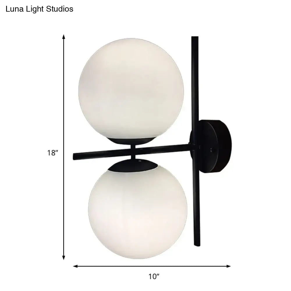 Modern black and white spherical wall light fixture with two frosted glass globes for living room use